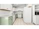 Bright kitchen with white cabinets, modern appliances, and light green lower cabinets at 3607 Springhollow Ct, Efland, NC 27243