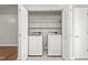 Functional laundry room with washer and dryer, plus shelving at 3607 Springhollow Ct, Efland, NC 27243