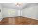 Hardwood floors accent this open living area, featuring windows and neutral paint at 3607 Springhollow Ct, Efland, NC 27243
