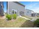 Backyard view featuring a well-maintained lawn and an enclosed patio at 361 Natsam Woods Way, Wake Forest, NC 27587