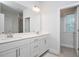Bright primary bathroom featuring double sink vanity, large mirror, and modern fixtures at 361 Natsam Woods Way, Wake Forest, NC 27587