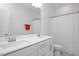 Bright bathroom with double sinks, white cabinets, and a well-lit mirror at 361 Natsam Woods Way, Wake Forest, NC 27587