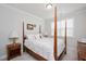 Well-lit bedroom featuring a four poster bed and traditional decor at 361 Natsam Woods Way, Wake Forest, NC 27587