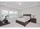 Bright bedroom features tray ceiling, carpeted floor, and sun-filled windows at 361 Natsam Woods Way, Wake Forest, NC 27587