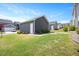 Detached garage with a white door and well-manicured lawn in a residential neighborhood at 361 Natsam Woods Way, Wake Forest, NC 27587