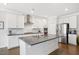 Modern kitchen featuring stainless steel appliances, large island, and white cabinetry at 361 Natsam Woods Way, Wake Forest, NC 27587