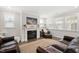 Comfortable living room features a fireplace, plush seating, and bright windows at 361 Natsam Woods Way, Wake Forest, NC 27587