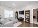 Cozy living room with hardwood floors, bookshelves, and lots of natural light at 361 Natsam Woods Way, Wake Forest, NC 27587