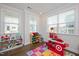 Bright playroom with hardwood floors, lots of natural light, and colorful toy storage at 361 Natsam Woods Way, Wake Forest, NC 27587