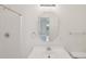 Well-lit bathroom featuring a large, uniquely shaped mirror and a sink at 403 Brookgreen Dr, Chapel Hill, NC 27516