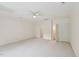Spacious bedroom with neutral carpet and ceiling fan with doors leading to other rooms at 403 Brookgreen Dr, Chapel Hill, NC 27516