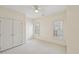 Neutral bedroom with bright windows, shutters, and a closet with bi-fold doors at 403 Brookgreen Dr, Chapel Hill, NC 27516