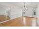 Formal dining room boasts hardwood floors, large chandelier and detailed crown moulding at 403 Brookgreen Dr, Chapel Hill, NC 27516