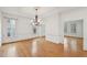 Open dining room features hardwood floors, large windows, and elegant crown moulding at 403 Brookgreen Dr, Chapel Hill, NC 27516