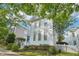 Charming two-story home with white siding, a blue front door, and a lovely tree-lined street at 403 Brookgreen Dr, Chapel Hill, NC 27516