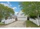 This home offers a white exterior, two-car garage and a classic white picket fence at 403 Brookgreen Dr, Chapel Hill, NC 27516