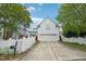 Charming two-story home featuring a white picket fence, two car garage and mature trees at 403 Brookgreen Dr, Chapel Hill, NC 27516