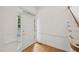 Bright foyer with hardwood floors, staircase, transom window, and a white front door at 403 Brookgreen Dr, Chapel Hill, NC 27516