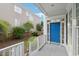 A blue front door with sidelights is the focal point from this covered front porch with white railings at 403 Brookgreen Dr, Chapel Hill, NC 27516