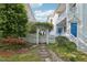 A beautiful white picket fence with an archway, leading to the front of the charming home at 403 Brookgreen Dr, Chapel Hill, NC 27516