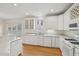 Bright kitchen with white cabinets, countertops, stainless appliances and hardwood floors at 403 Brookgreen Dr, Chapel Hill, NC 27516