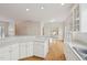 Bright kitchen with white cabinets, countertops, and open layout to adjacent rooms at 403 Brookgreen Dr, Chapel Hill, NC 27516