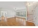Bright living room with fan lighting, hardwood floors, and staircase at 403 Brookgreen Dr, Chapel Hill, NC 27516