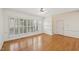 Bright living room featuring hardwood floors and large windows with shutter-style blinds at 403 Brookgreen Dr, Chapel Hill, NC 27516