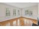 Bright living room with hardwood floors, plantation shutters, and fireplace detail at 403 Brookgreen Dr, Chapel Hill, NC 27516