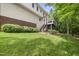 Large backyard with lush greenery and an outdoor deck area at 408 Evert Dr, Cary, NC 27511