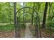 Tranquil garden path leading through a lush, wooded backyard at 408 Evert Dr, Cary, NC 27511