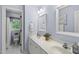 Bright bathroom featuring dual sinks, vanity, and a separate water closet at 408 Evert Dr, Cary, NC 27511