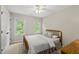 Cozy bedroom with neutral walls, ceiling fan, and ample natural light from the windows at 408 Evert Dr, Cary, NC 27511