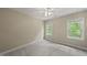 This bedroom features plush carpeting, neutral walls, and two windows for natural light at 408 Evert Dr, Cary, NC 27511
