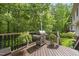 Spacious outdoor deck area featuring a stainless steel grill and lush greenery at 408 Evert Dr, Cary, NC 27511