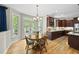 Sunlit dining area with hardwood floors, a chandelier, and french doors at 408 Evert Dr, Cary, NC 27511