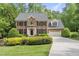 Charming brick home featuring black shutters, a well-manicured lawn, and a two car garage at 408 Evert Dr, Cary, NC 27511