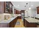 Kitchen with dark wood cabinets, a granite island, and stainless steel appliances at 408 Evert Dr, Cary, NC 27511