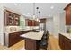 Kitchen with granite countertops, an island with bar seating, and rich wood cabinetry at 408 Evert Dr, Cary, NC 27511