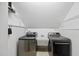 Modern laundry room with stainless steel appliances and ample storage at 408 Evert Dr, Cary, NC 27511