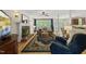 Spacious living room featuring a brick fireplace, large windows, and hardwood flooring at 408 Evert Dr, Cary, NC 27511