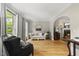 Inviting living room with a cozy fireplace, hardwood floors, and large windows offering natural light at 408 Evert Dr, Cary, NC 27511
