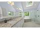 Bright main bathroom with skylight, double vanity, soaking tub and glass shower at 408 Evert Dr, Cary, NC 27511
