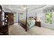 Spacious main bedroom with a four poster bed, tray ceiling, and large windows at 408 Evert Dr, Cary, NC 27511