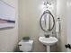 Well-lit powder room with modern fixtures, decorative mirror, and charming accents at 408 Evert Dr, Cary, NC 27511
