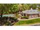 Aerial view of the community clubhouse, pool, and outdoor seating area surrounded by mature trees at 4101 John S Raboteau Wynd, Raleigh, NC 27612