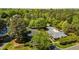 Aerial view of the community clubhouse, parking area, and pool nestled amongst lush trees at 4101 John S Raboteau Wynd, Raleigh, NC 27612