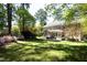 Sprawling lawn and lush landscaping make this home's backyard feel like a private retreat at 4101 John S Raboteau Wynd, Raleigh, NC 27612