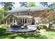 Expansive brick home featuring an inviting stone patio with ample seating and outdoor cooking area at 4101 John S Raboteau Wynd, Raleigh, NC 27612