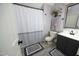 Well-maintained bathroom with a shower and tub combo and gray-toned fixtures and decor at 4101 John S Raboteau Wynd, Raleigh, NC 27612